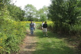 Henriksen and Hartnett lead a group through the course