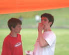 Alex stares incredulously as Dolan downs a dog