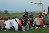 Coach Shaklee congratulates the team on a hard-fought victory