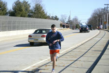 Kevin checks his watch at a mile marker